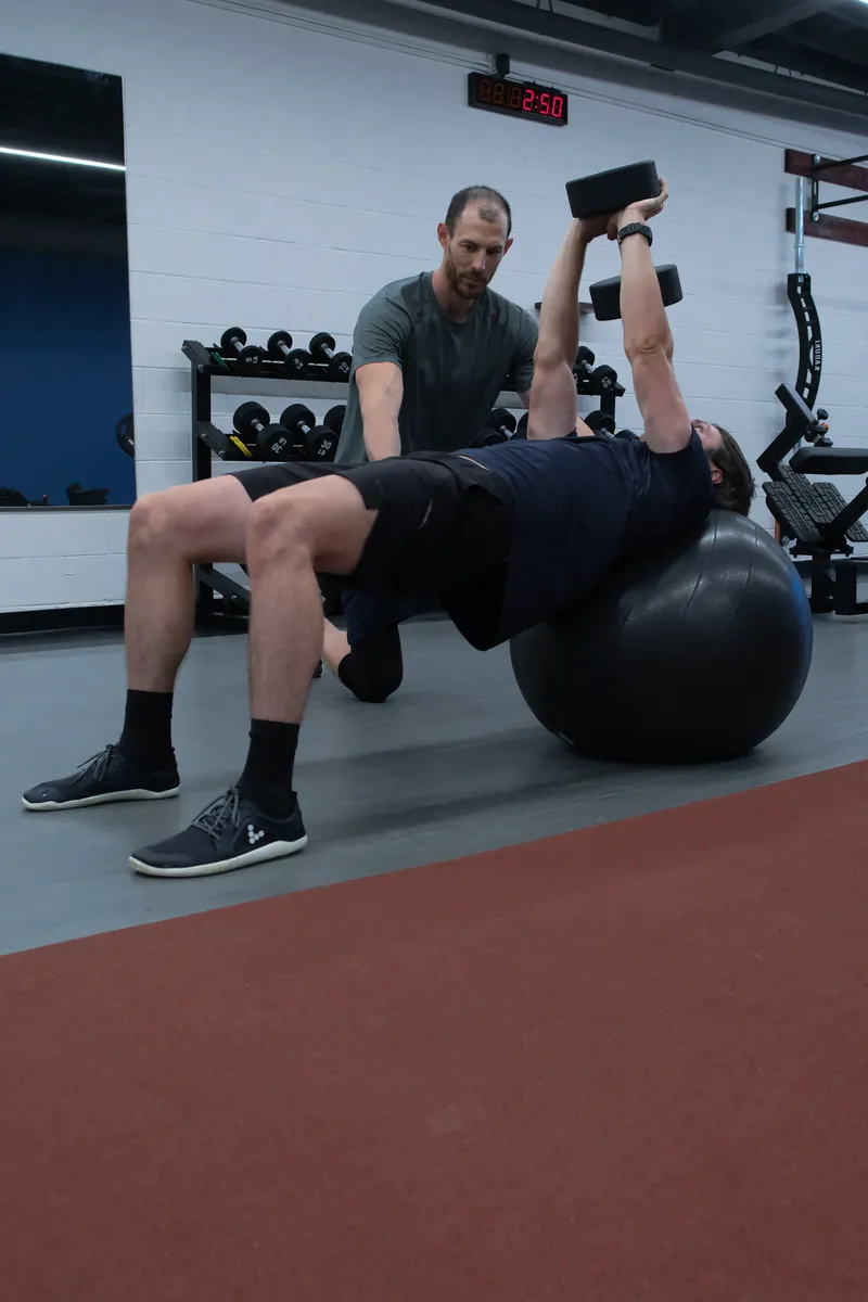 Chest press on a stability ball during a spotted set